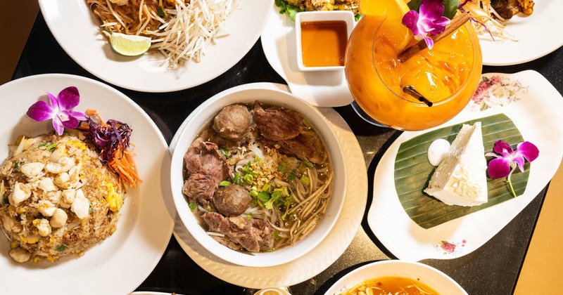 Interior featuring lush green plants and decorative peacock statues