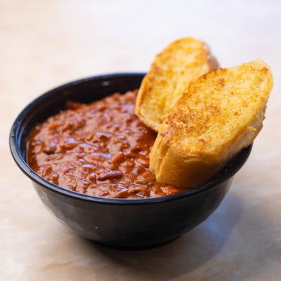 Spaghetti with chili and garlic bread.