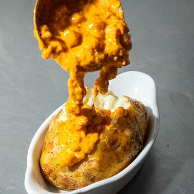 Cheese sauce poured over baked potato.