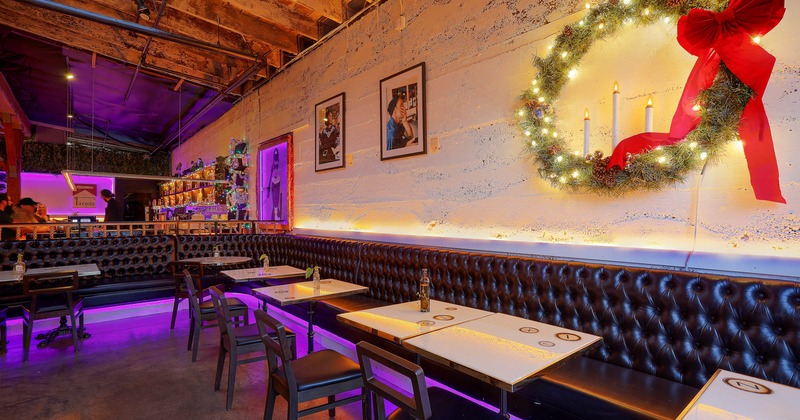 Interior, seating area, long corner banquette bench with tables and  chairs