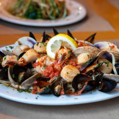 Seafood mix in tomato sauce and linguine pasta.
