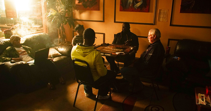 Interior, people play board games