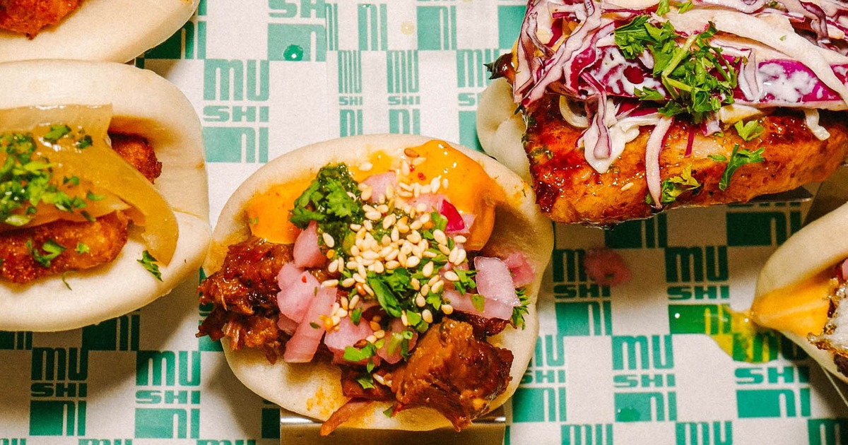 Fluffy steamed bao buns filled with colorful savory Asian street food