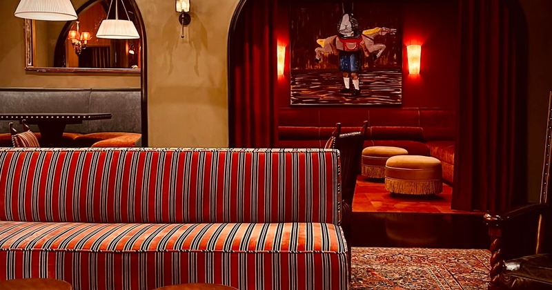 Cozy room with a striped red sofa, dim lighting, and elegant decor