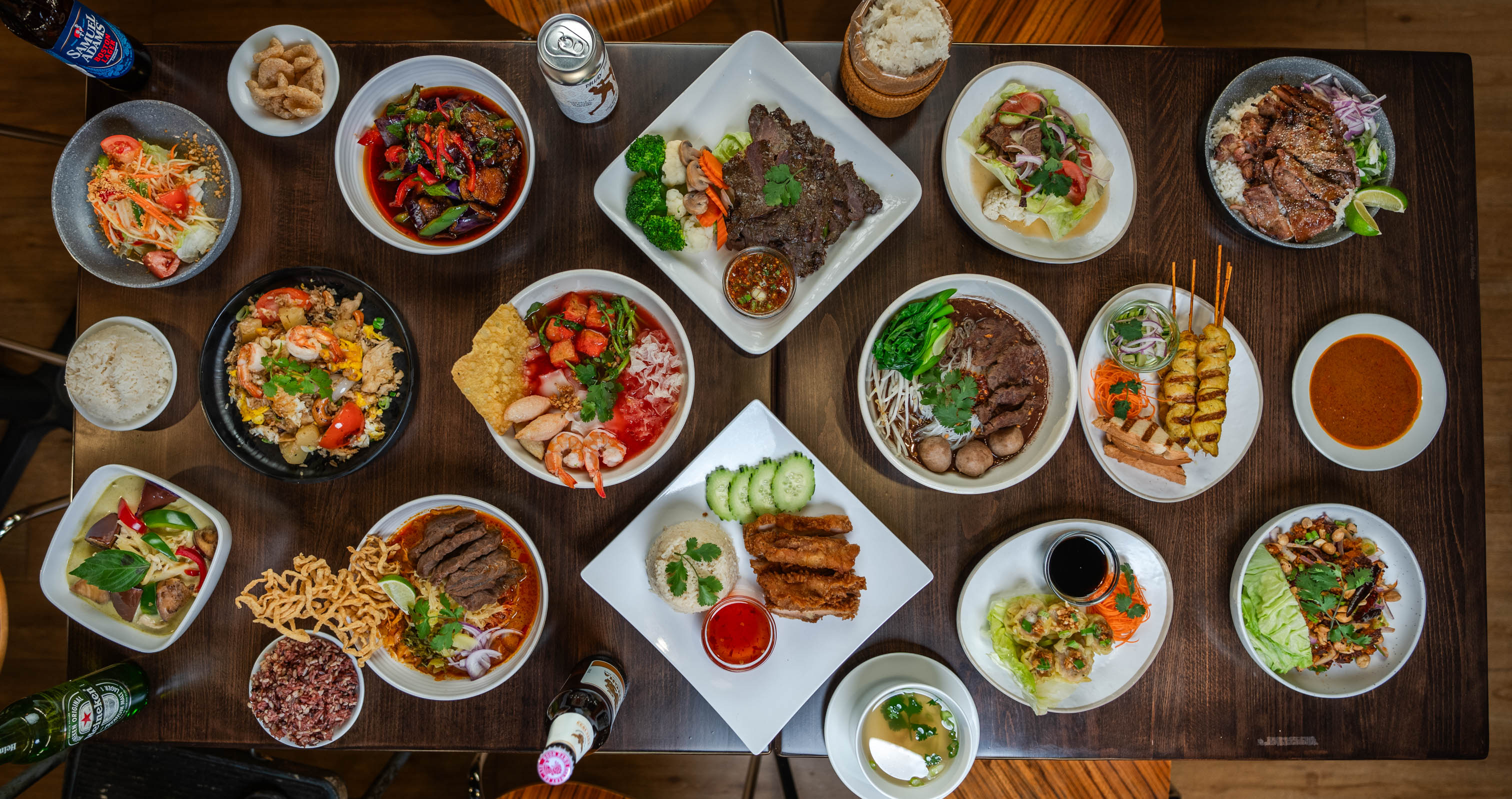 Assorted Thai dishes arranged on wooden table