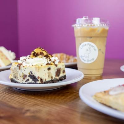 Cheesecake and iced coffee on a table.