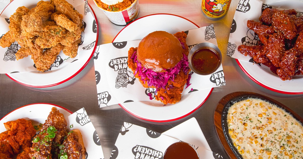 Fried chicken sandwich served with alongside other menu items and canned drink