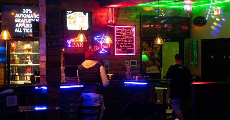 Interior, bar, standing tables, guests at the bar