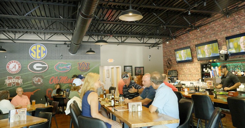 Dining area, guests, tables and bar chairs