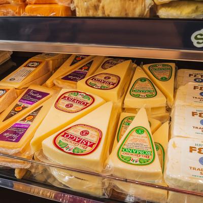 Dairy shelves, assorted cheeses.