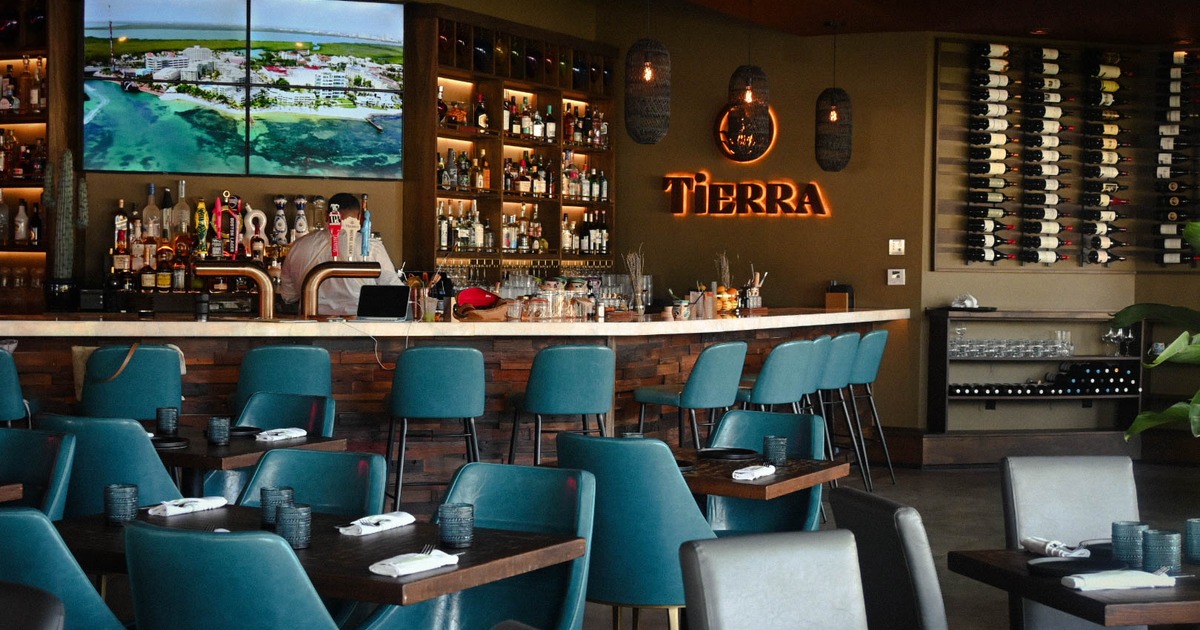 Interior, dining and bar area, wooden top tables for four and two, bar with stools