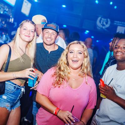 Smiling people on the dance floor.