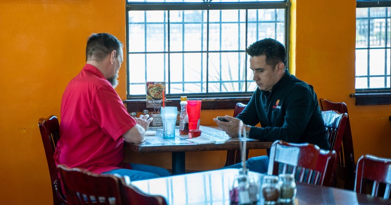 Diner tables, chairs, people eating