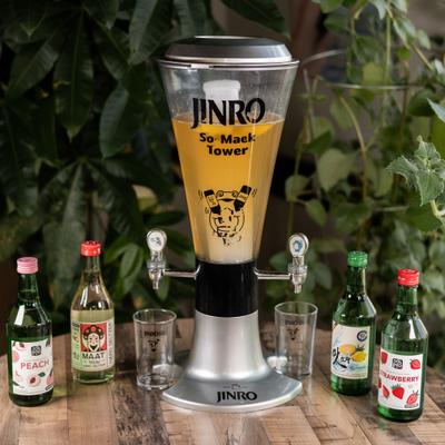 Beverage dispense tower alongside bottles of soju and glasses.
