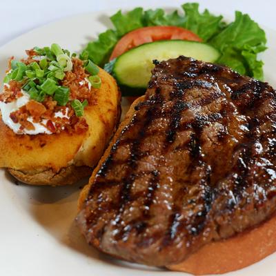 Grilled steak, baked potato, and salad.