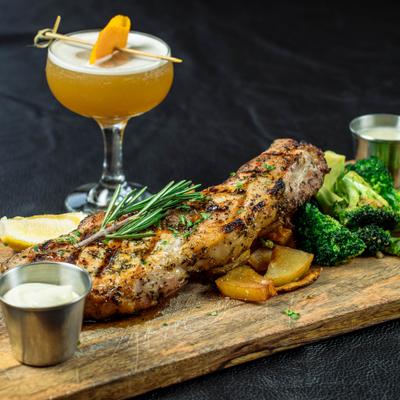 Grilled pork chop with potatoes and broccoli.