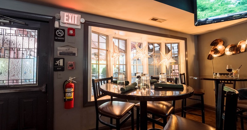 Interior, bar table, chairs, window behind