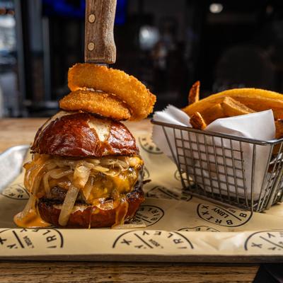 Cheeseburger with chipotle sauce, caramelized onions, and onion rings.