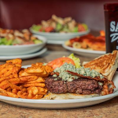 Bacon burger with blue cheese and sweet potato waffle fries.