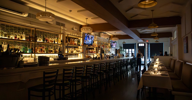 Interior decor featuring a large faux cherry blossom tree and the restaurant wall sign