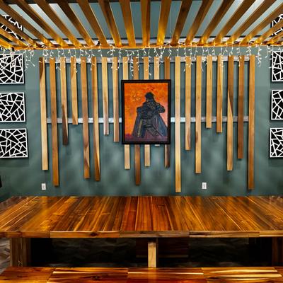 Interior, seating with a wooden table, benches and decor on a wall.