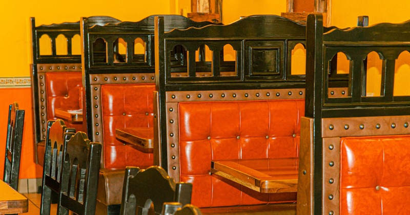 Interior, tables, red leather seating booths lined up