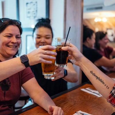 Inside, a group of guests toasting with drinks.