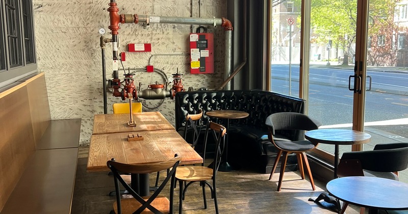 Cozy, industrial-style seating area by large windows