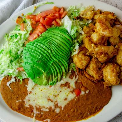 Breaded shrimp, served with lettuce, tomato, avocado, and refried beans.