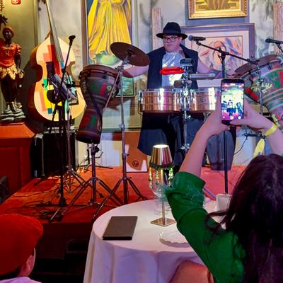 Pedrito camacho playing instruments on the stage.