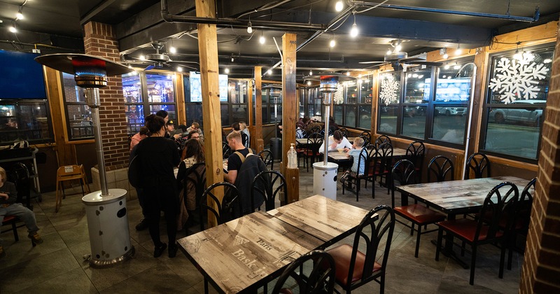 Covered patio at night with guests enjoying their food