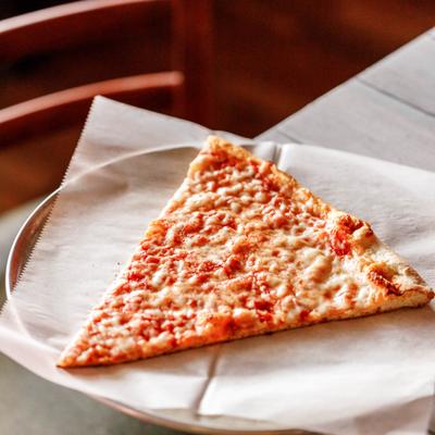 Slice of cheese pizza served on a plate.