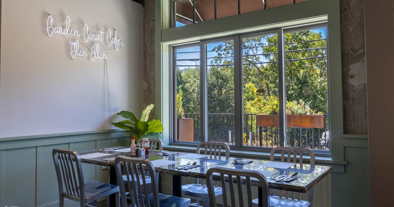 A table for six people placed next to a large window