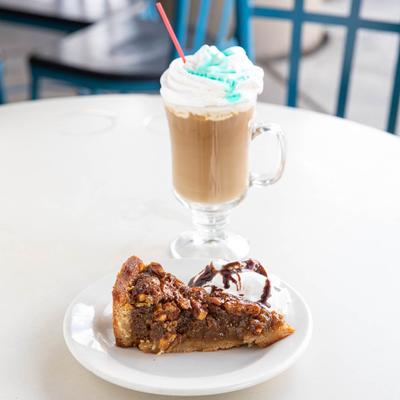 Deep Dish Bourbon Pecan Pie plate and a glass of cream coffee