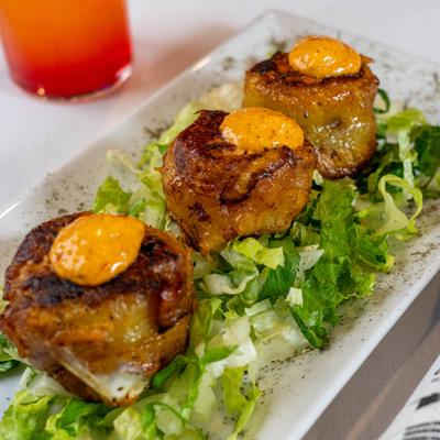 Fried sweet plantain rolls filled with beef.
