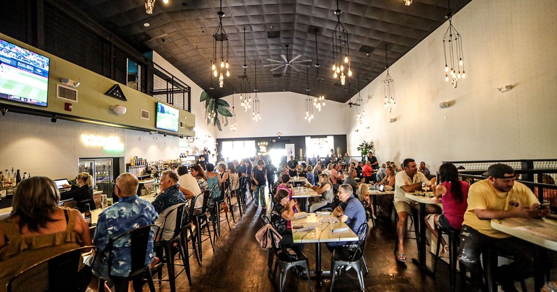 Restaurant interior, seating area full of guests