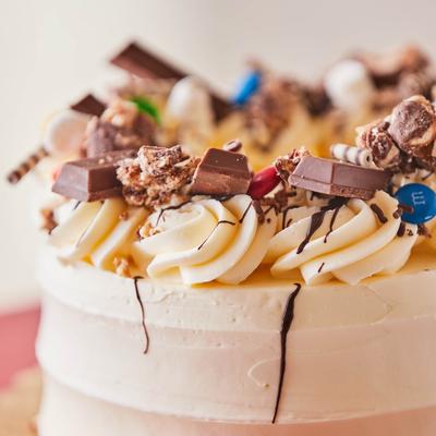 Cake with variety of sweets on top