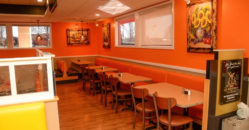 Dining area, long tufted banquette seating with tables and chairs