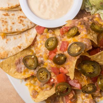Quesadillas, nachos with peppers and pico de gallo, guacamole, sour cream and cheese