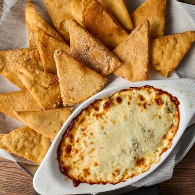 Spinach artichoke dip, served, top view.
