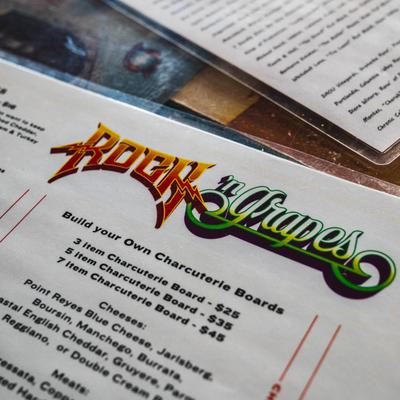 A close up of Rock N Grapes menu on a table.