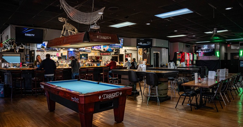 Interior, a pool table with a bar in the back