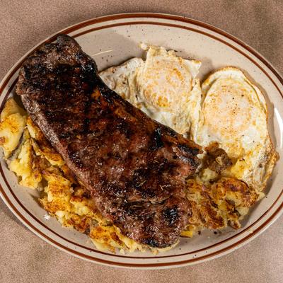 New York Strip Steak and Eggs served with home fries.