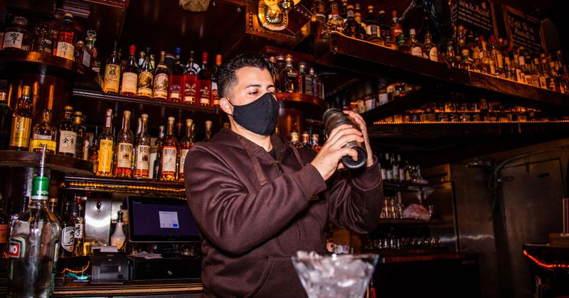 Staff member preparing cocktail