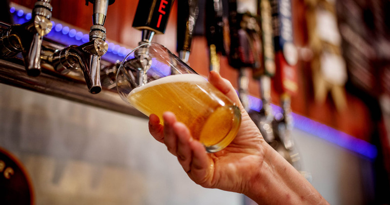 Staff member pouring beer
