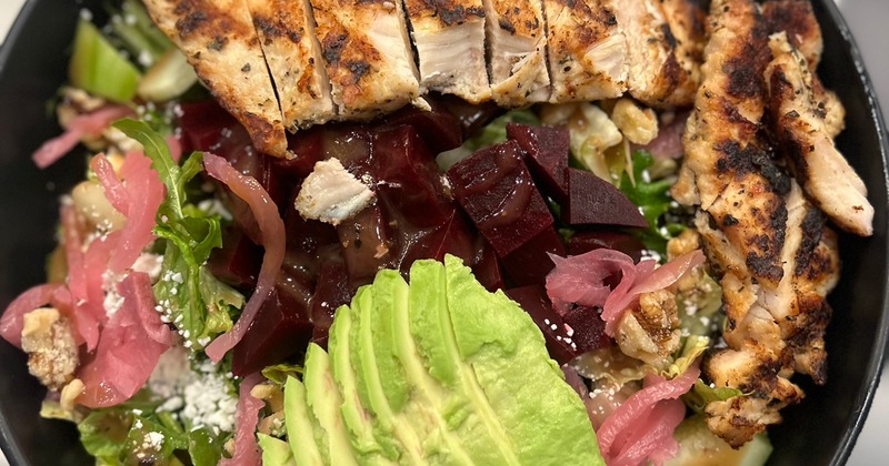 Salad with beets, avocado and grilled chicken, top view