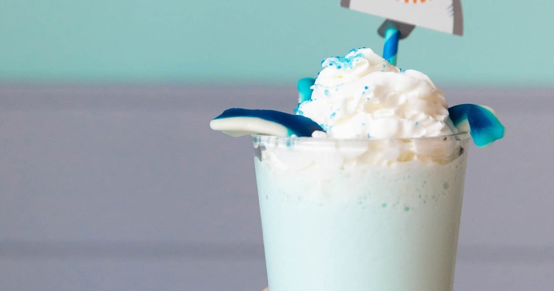 Hand with a glass of Shark Shake