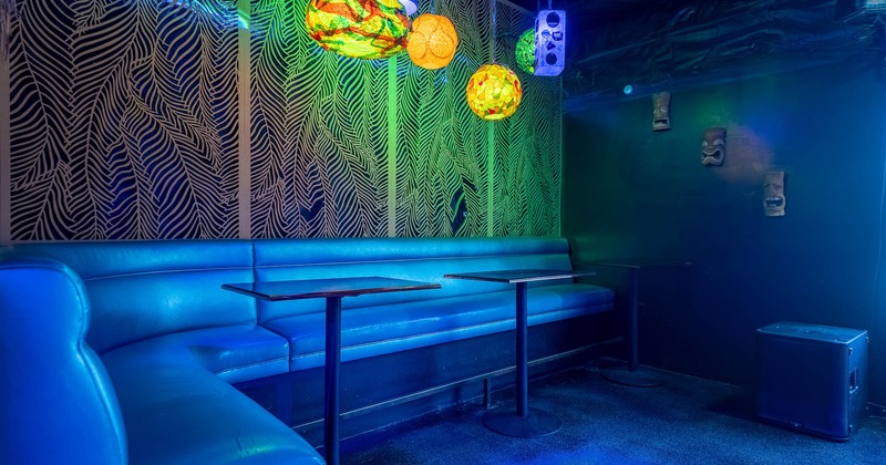 Lounge area with a booth, leaf-patterned wall
