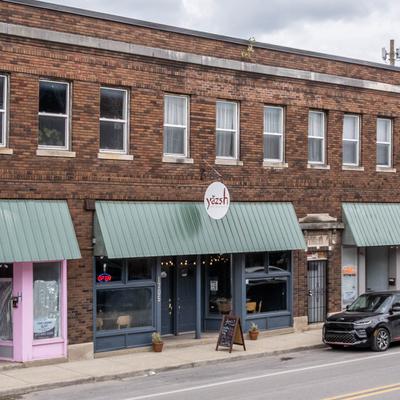 Exterior, storefront with green awning, entrance and signage.