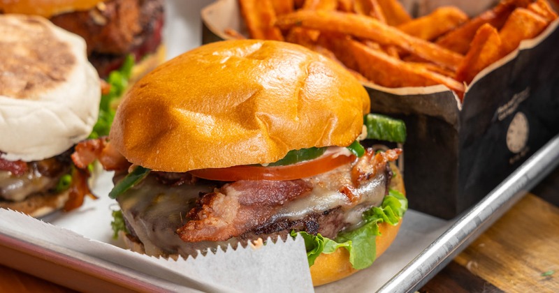Close up of a plate with assorted burgers and fries